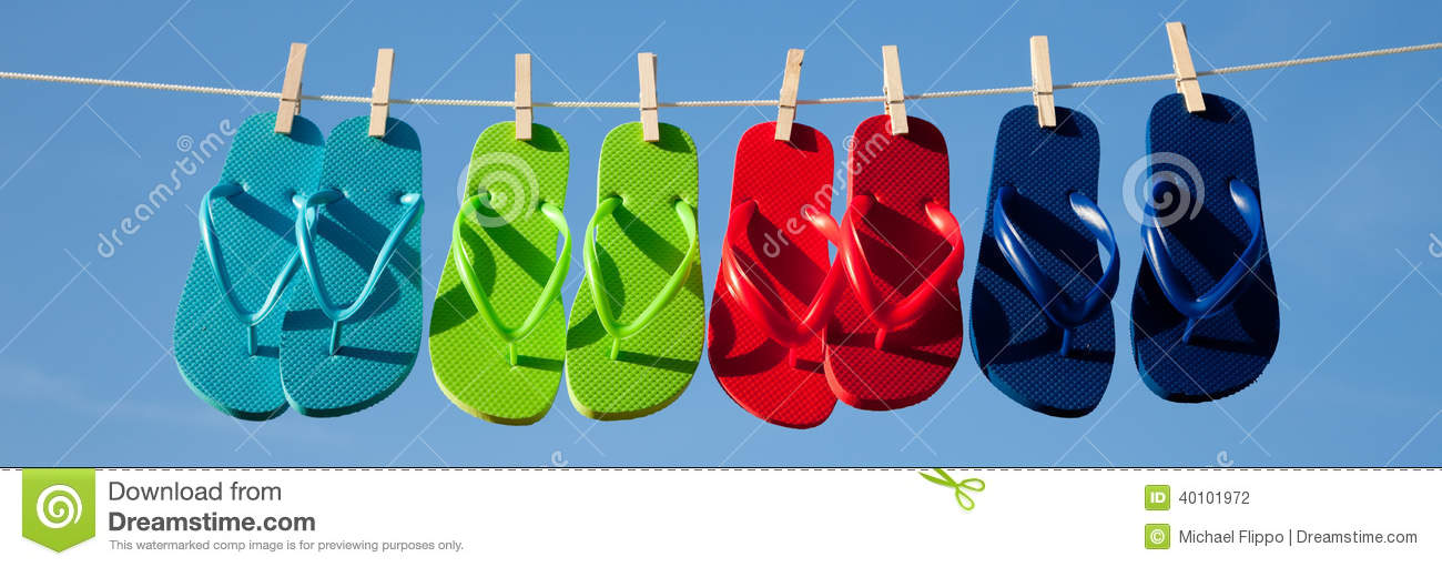Turquoise Green Red And Blue Flipflops On A Clothesline With The Sky    