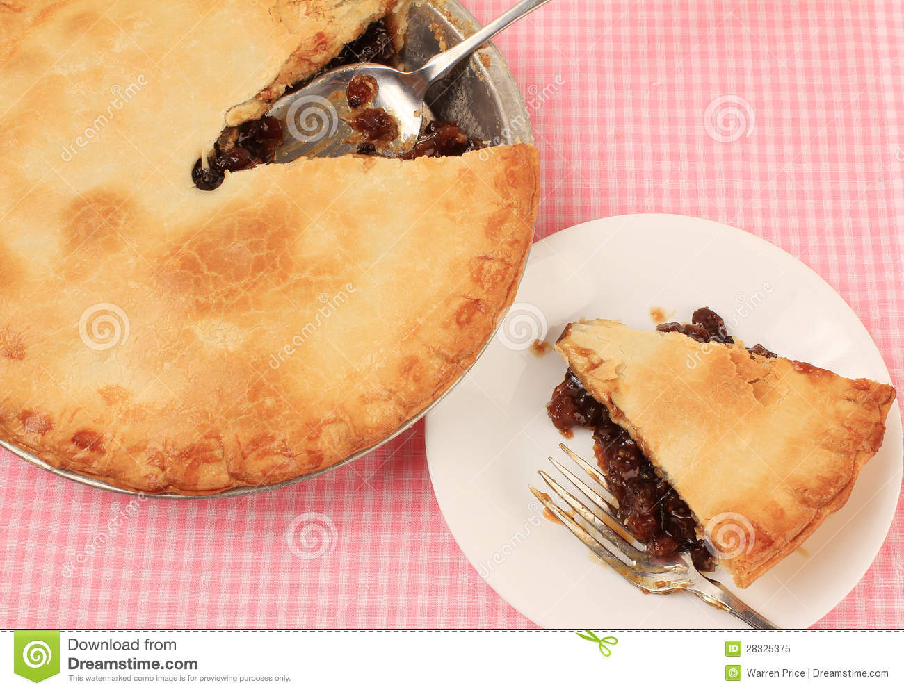 Mincemeat Pie With Slice On Plate Beside It Against Pink Gingham