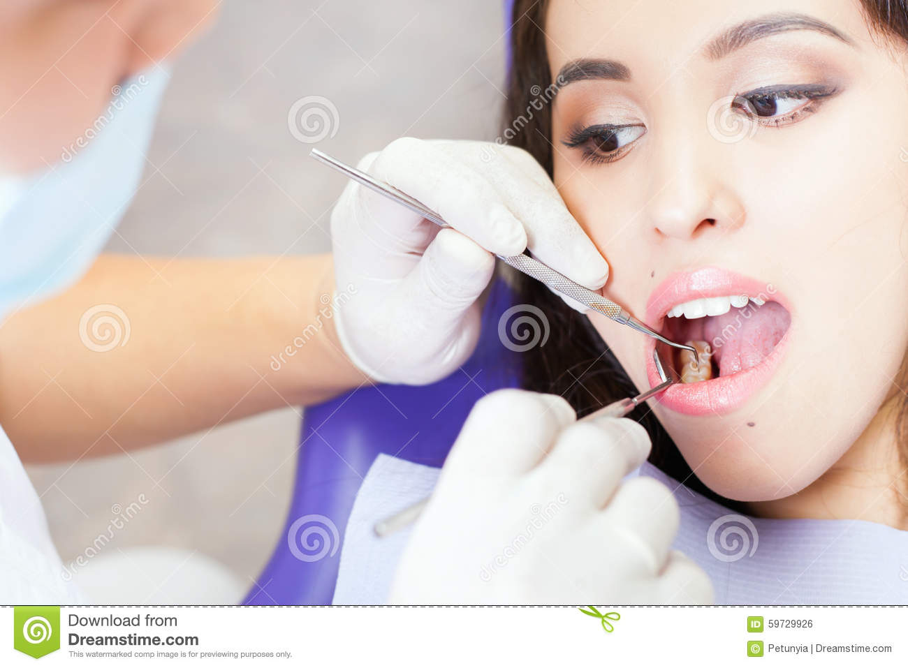 Doctor Treats Teeth Patient Girl In Dental Office  Regular Visits    