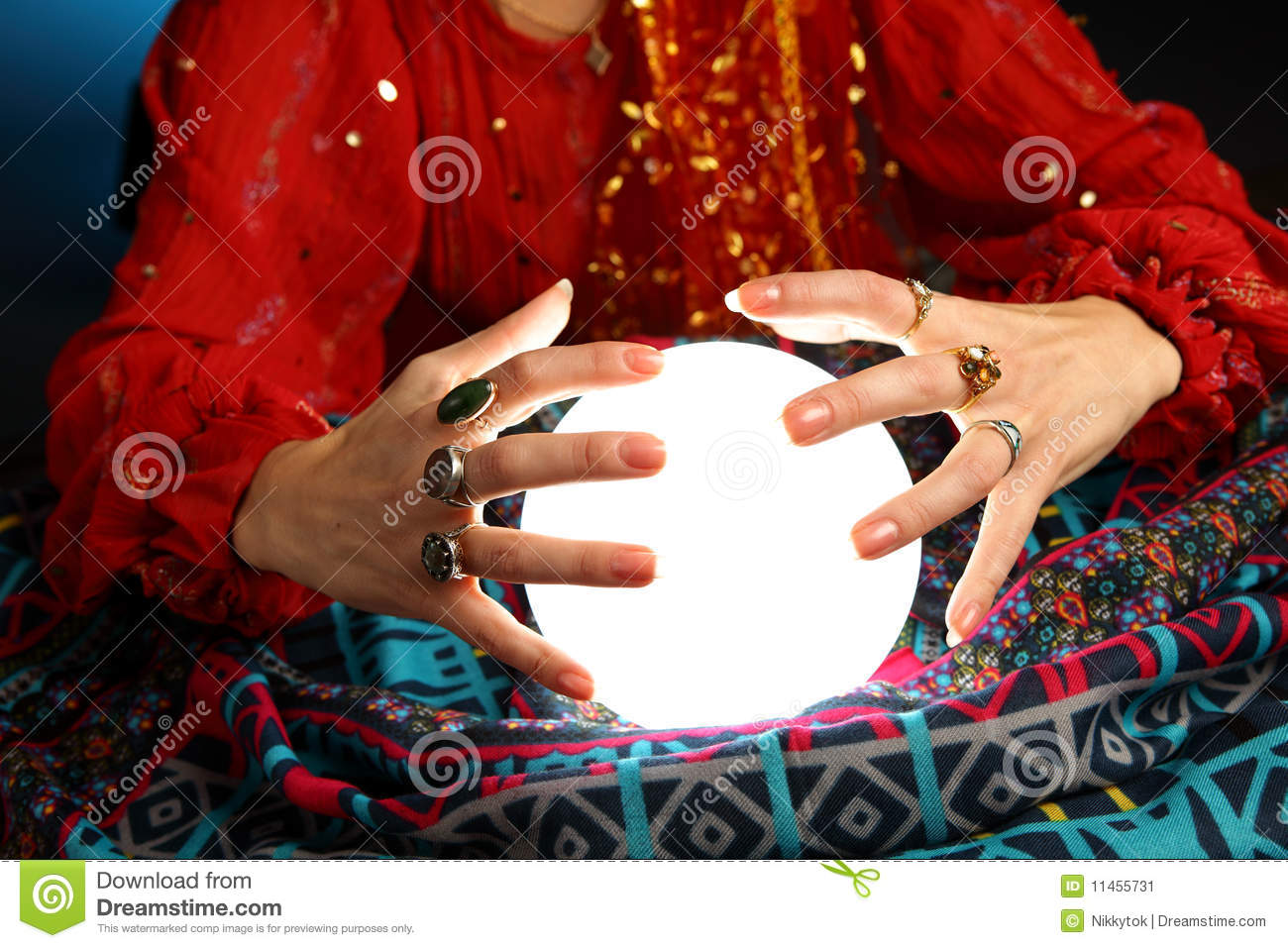 Hands Of A Fortune Teller Working With A Shining Crystal Ball