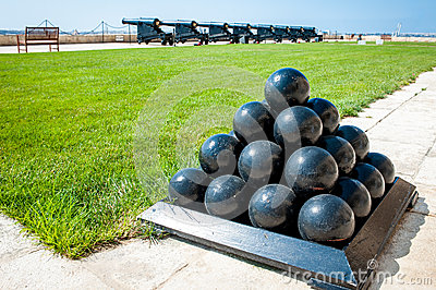 Old Cannonballs Stacked In Pyramid In Front Of Cannons On Valletta