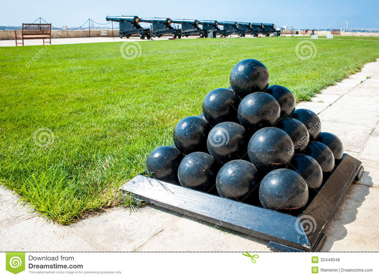 Old Cannonballs Stacked In Pyramid In Front Of Cannons On Valletta