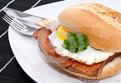 Roll With Meat Loaf And Fried Egg On A Plate