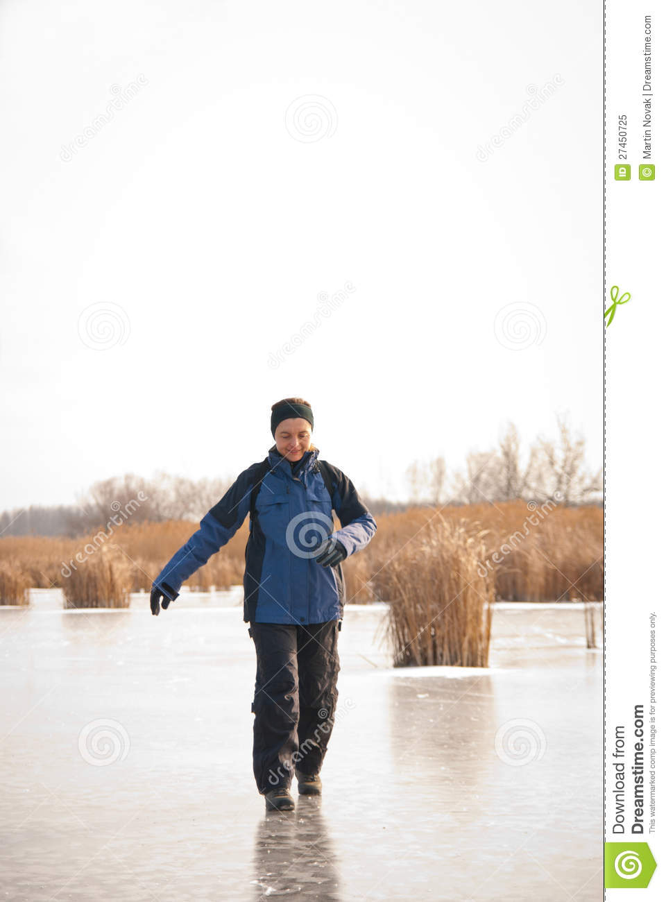 Young Smiling Woman Is Sliding On Ice   Winter Outdoor Scene