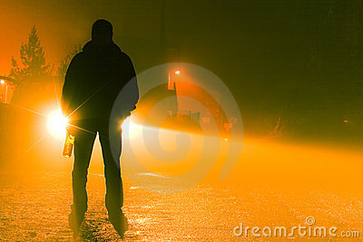 Silhouette Of A Drunk Person Standing On The Road On A Foggy Night