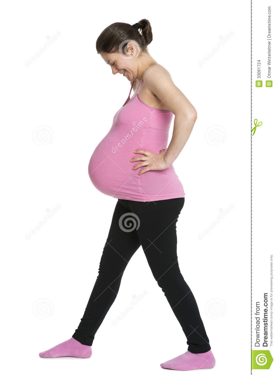 Joyful Pregnant Woman In Pink Undershirt With Hands On Hips Looking At