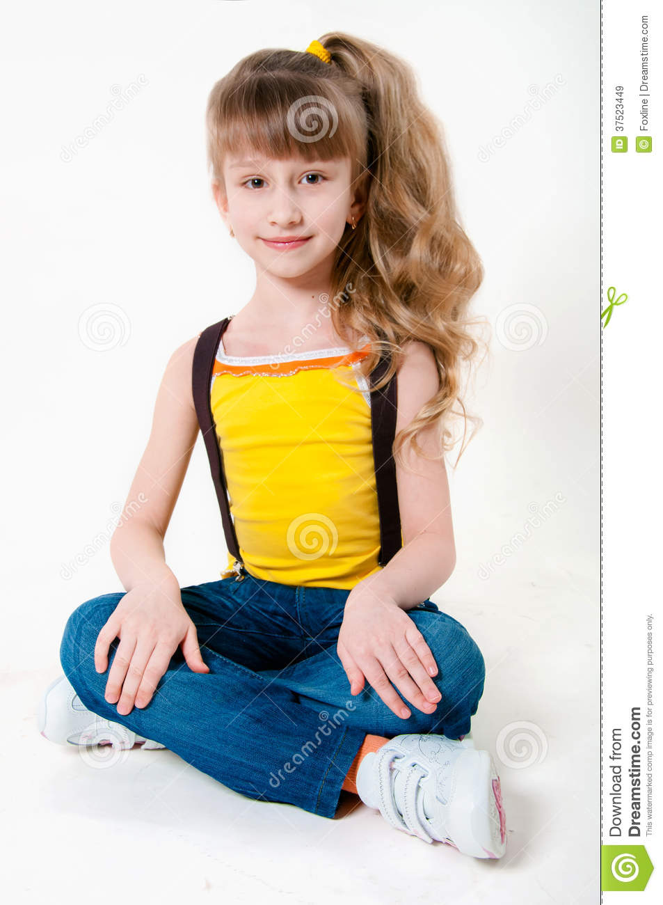 Little Girl In Jeans On A White Background Royalty Free Stock Images