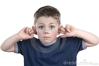 Young Boy With His Fingers In His Ears So He Can Not Hear
