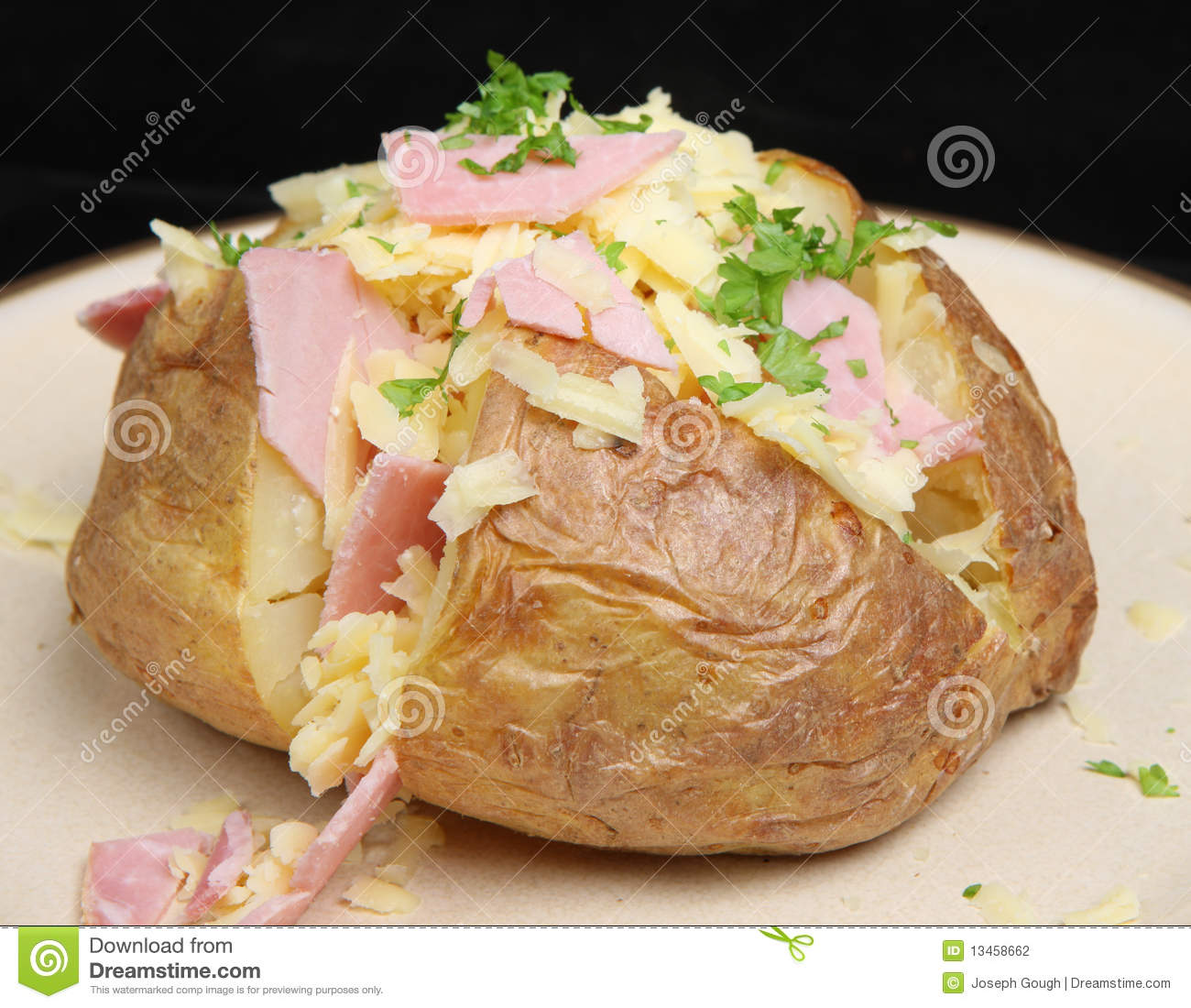 Jacket Potato Filled With Grated Cheddar Cheese And Ham 