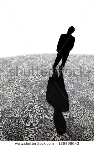 Silhouette Of A Man Casting A Long Shadow On A Cobble Stone Road