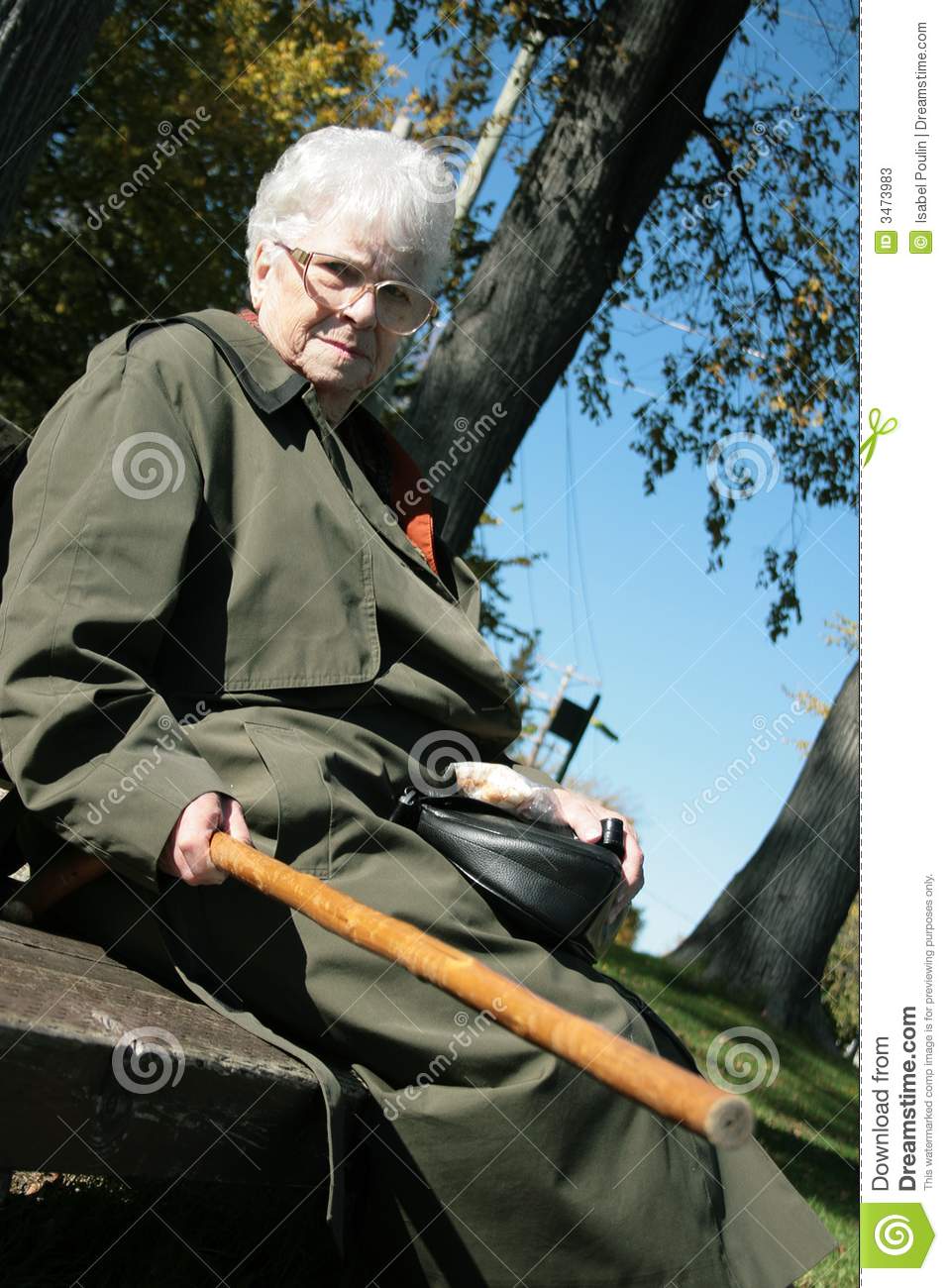 Grumpy Senior Woman Pointing Her Walking Stick At Someone