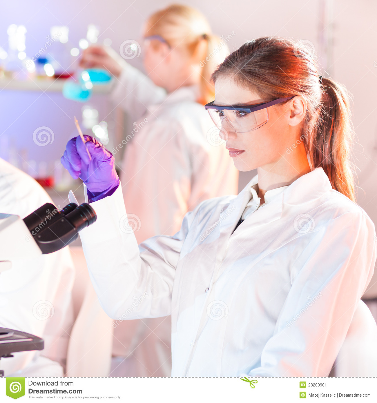 Attractive Young Researcher Looking At The Microscope Slide In The