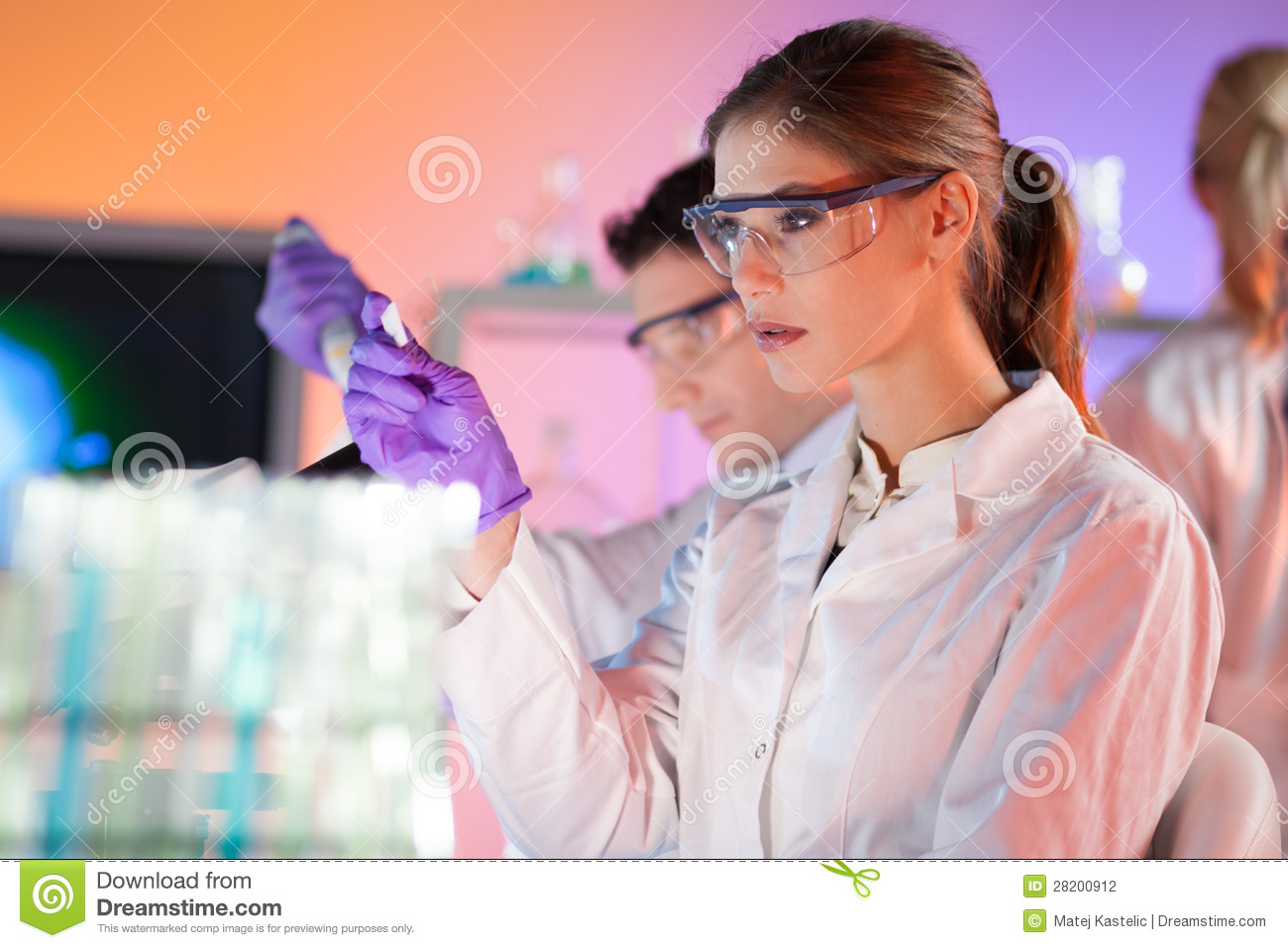 Attractive Young Scientist Looking At The Microscope Slide In The Life    