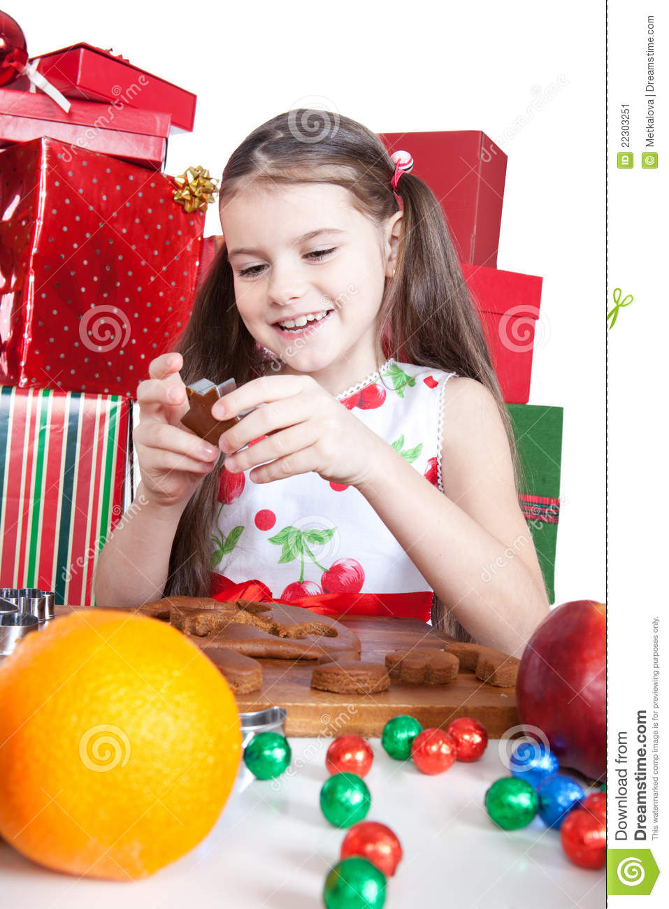 Cute Little Girl Making Christmas Cookies At A Table 