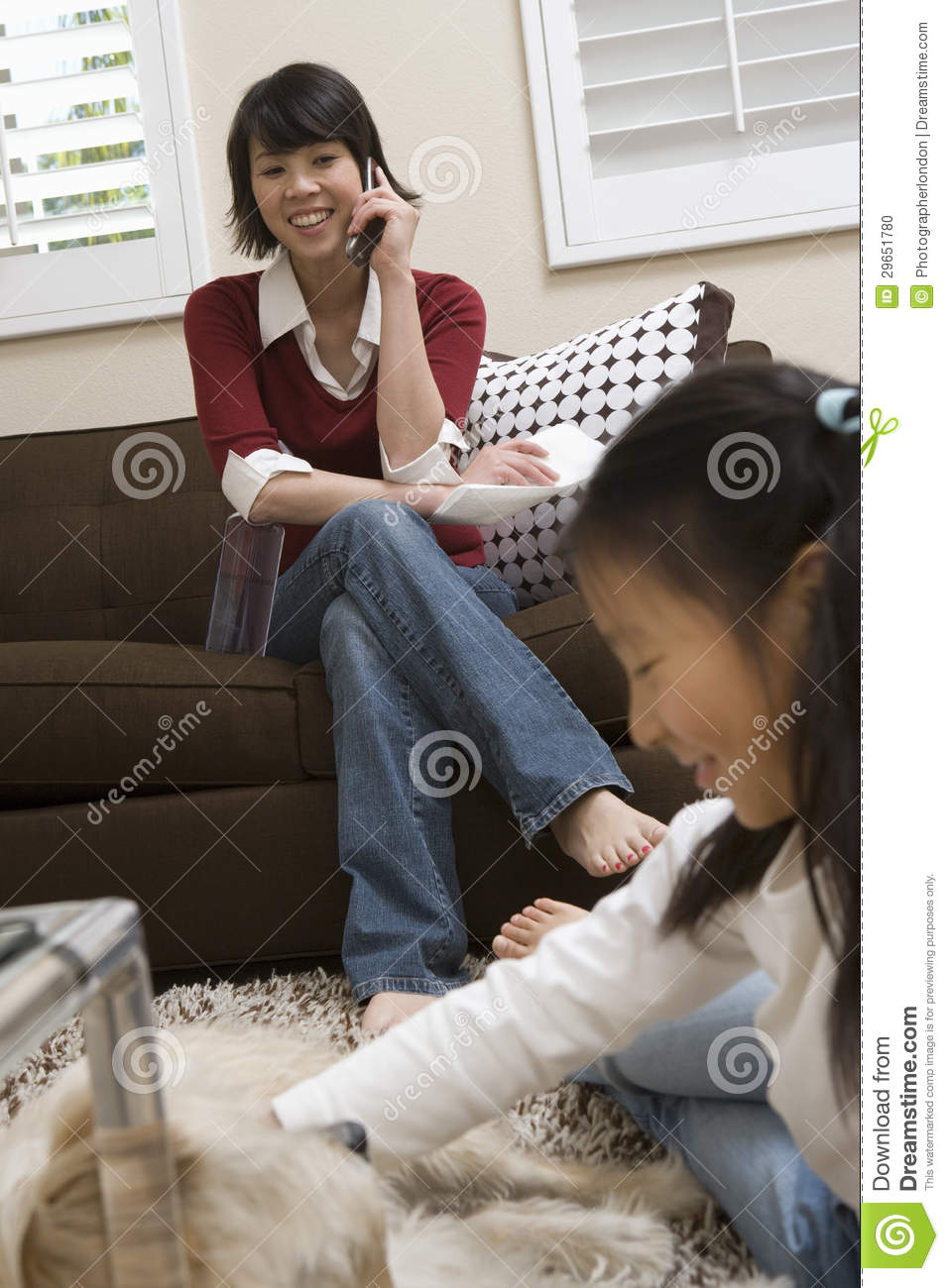 Girl Playing With Dog With Mother On Call Stock Photo   Image    