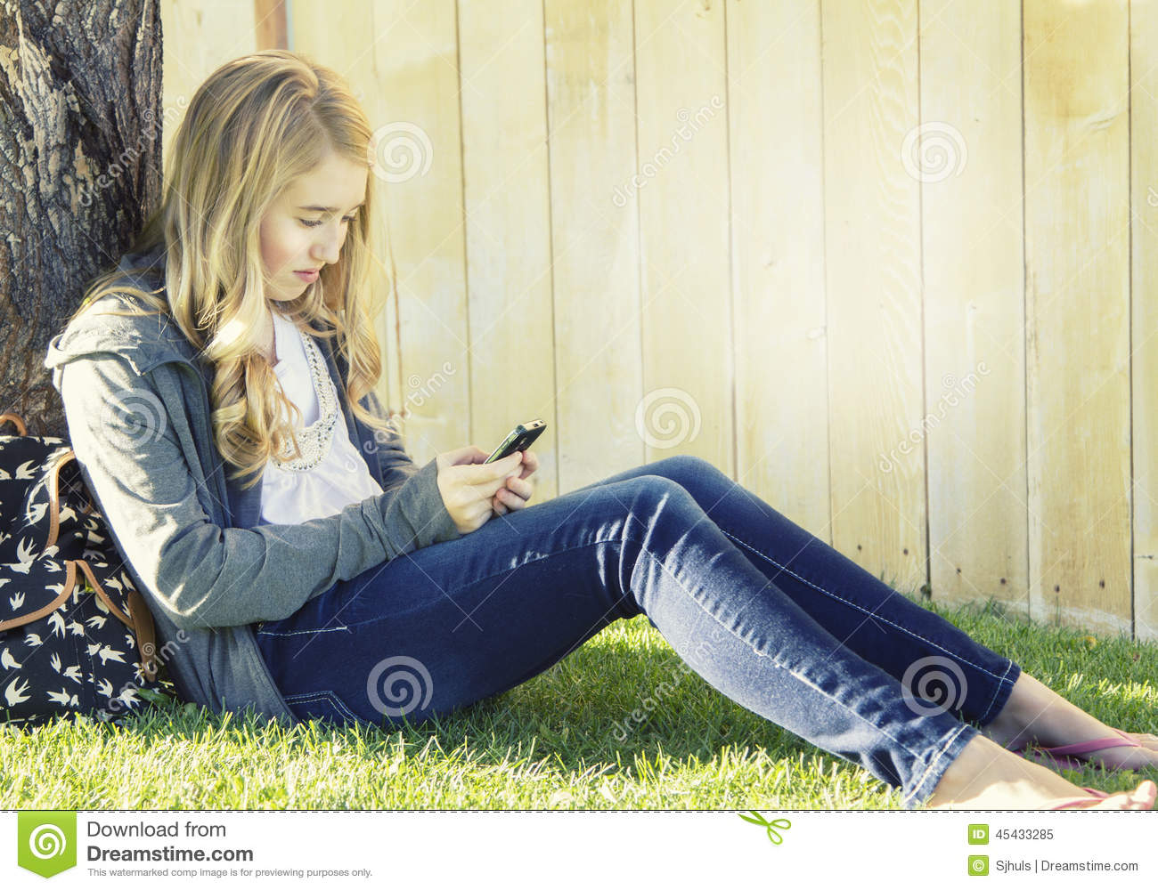 Girl Using A Cell Phone Texting Surfing The Internet Or Playing    