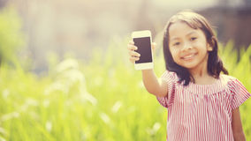 Happy Girl Playing Outdoor With Cellphone Royalty Free Stock Images