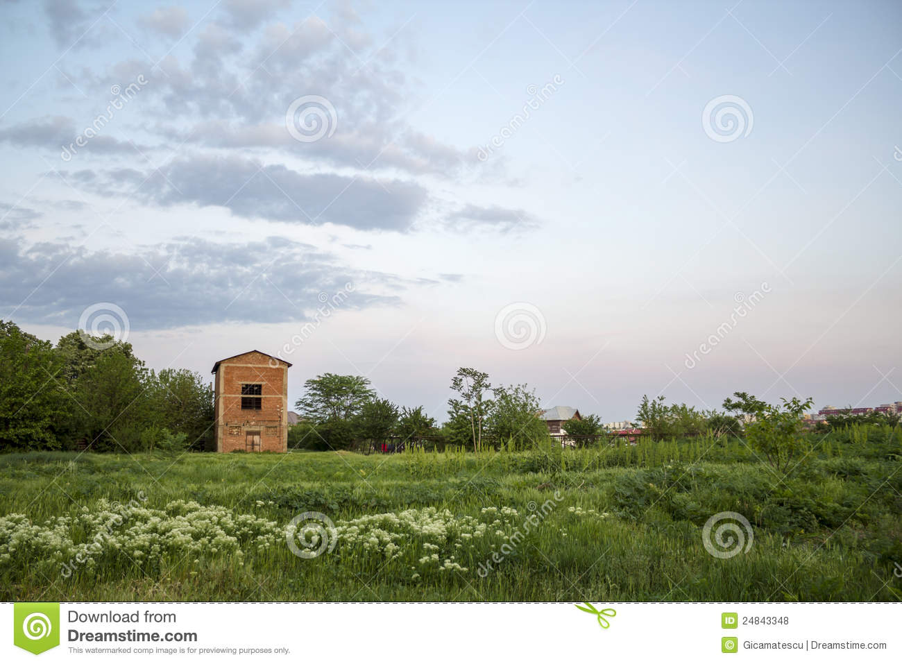 Vacant Land With A Unfinished Buildingduring The Evening