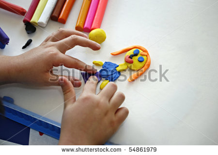 Hands Of Little Girl Making Doll From Colorful Clay Dough  Plasticine    