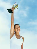 Close Up Of A Female Athlete Holding Up A Trophy