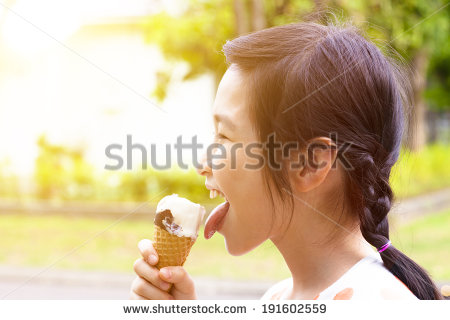 Happy Little Girl Eating Popsicle With Sunset Background   Stock Photo