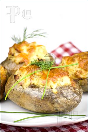 Stuffed Potatoes Covered With Cheddar Cheese Decorated With Chives And    