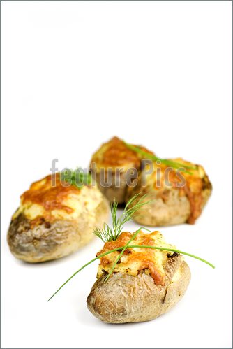 Stuffed Potatoes Covered With Cheddar Cheese Decorated With Chives And