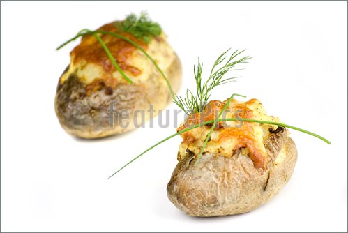 Stuffed Potatoes Covered With Cheddar Cheese Decorated With Chives And    