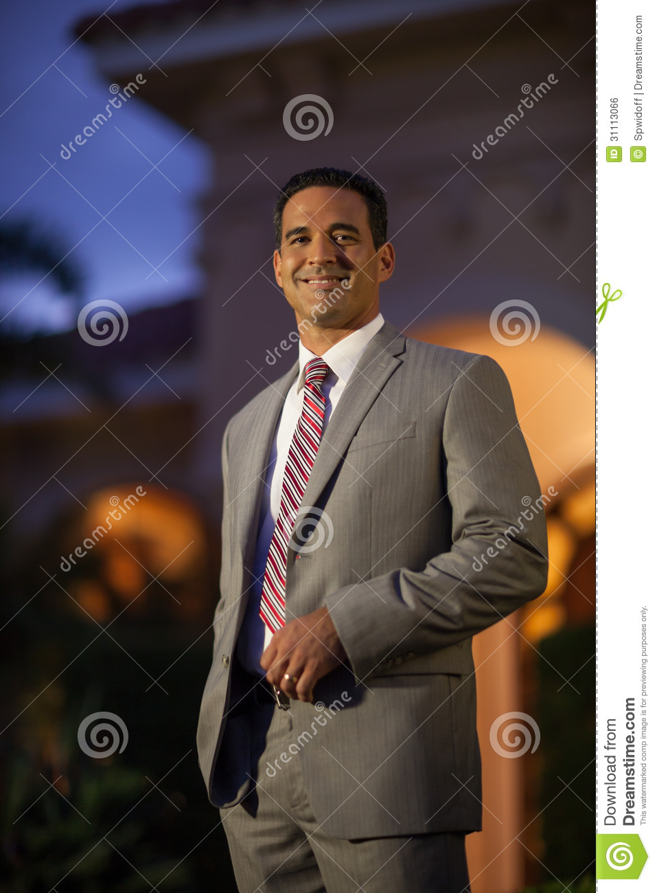 Handsome Brunette Hispanic Man Smiling Outside In Suit And Tie Infront