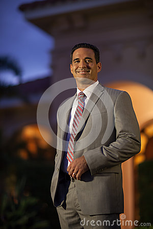 Handsome Brunette Hispanic Man Smiling Outside In Suit And Tie Infront