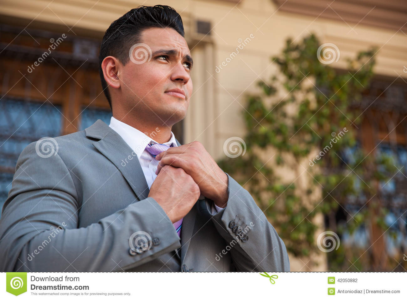 Man In A Suit Fixing His Tie Stock Photo   Image  42050882