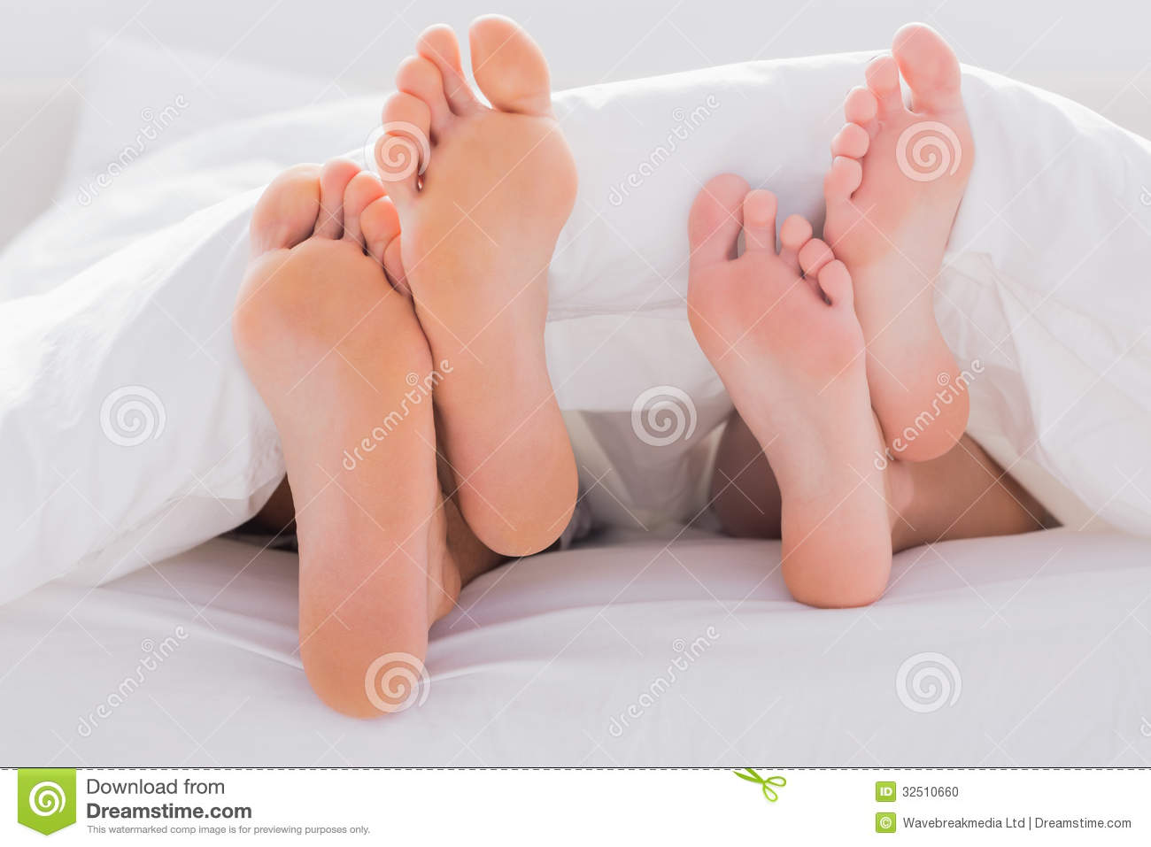 Couples Feet Crossed Under The Duvet Stock Photo   Image  32510660