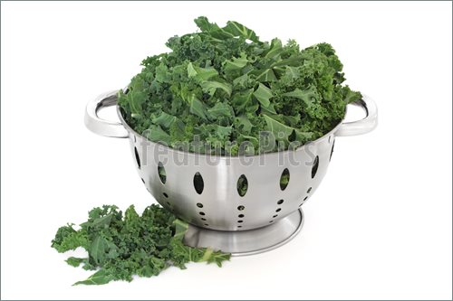 Kale Green Cabbage In A Stainless Steel Colander And Loose Over White