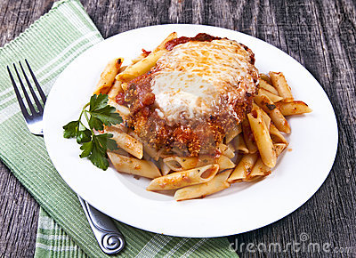 Chicken Parmigiana On A Wood Rustic Table Served On Top Of Pasta With