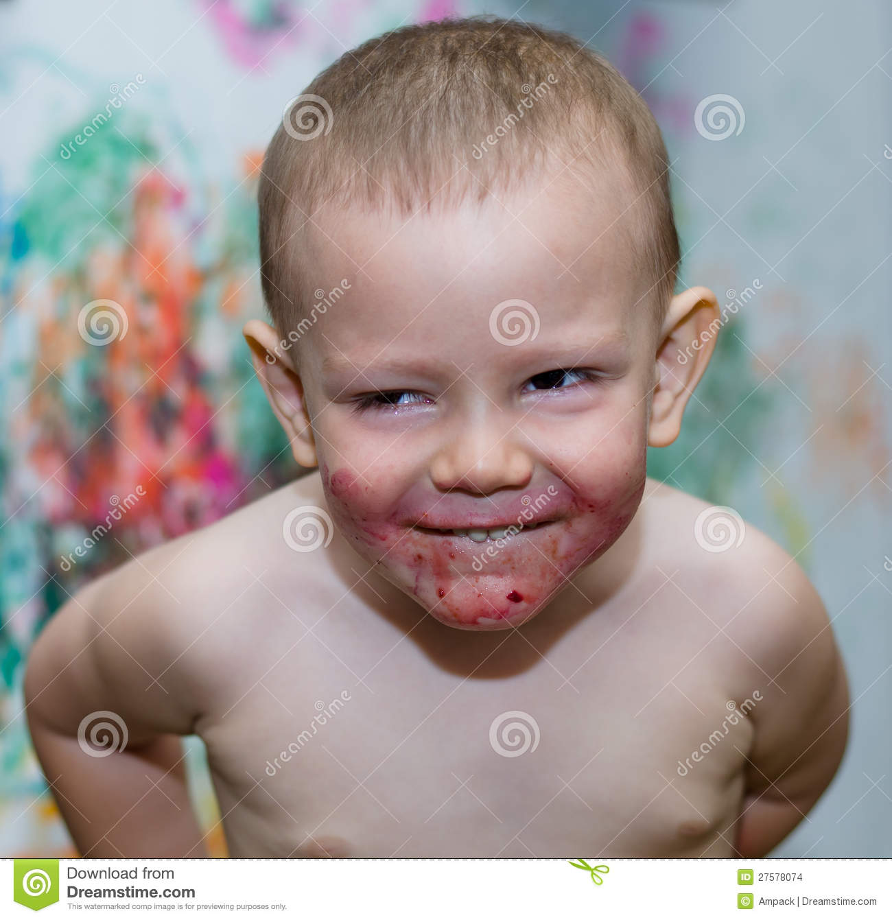 Boy With A Sheepish Grin And A Face Stained Red With Food Or Fruit