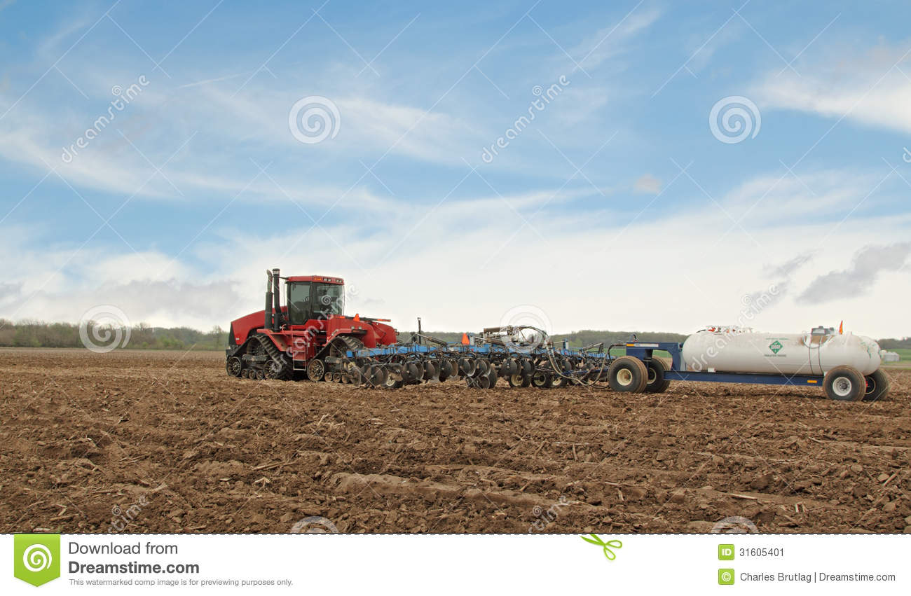Plowing Farm Field Red Tractor Pulling Plow Anhydrous Ammonia Tank