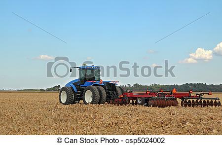 Stock Photo Of Blue Tractor   Blue Farm Tractor Pulling A Plow In A