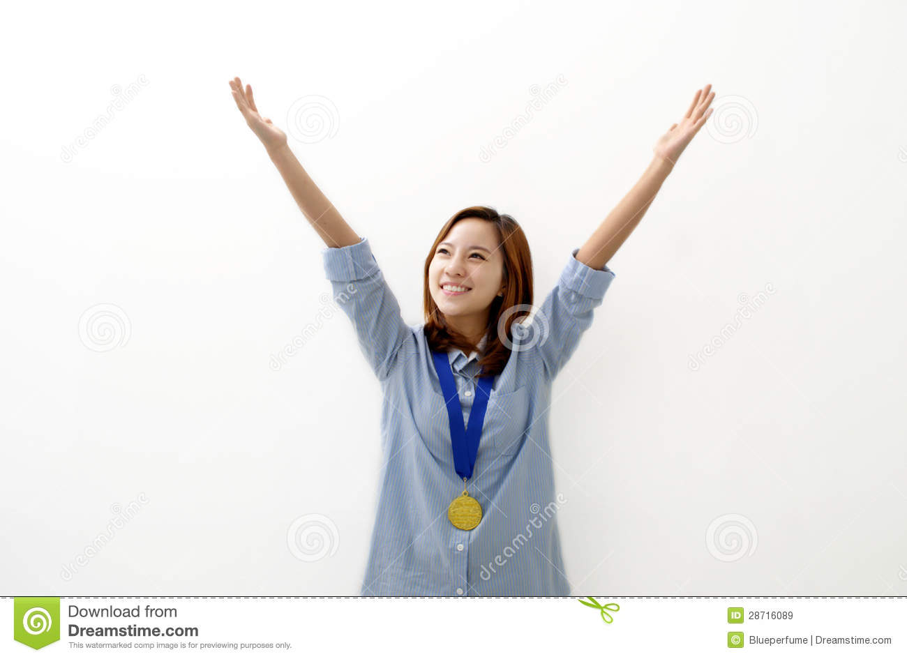     Woman Happily Holds Up Her Arms With A Gold Medal Around Her Neck