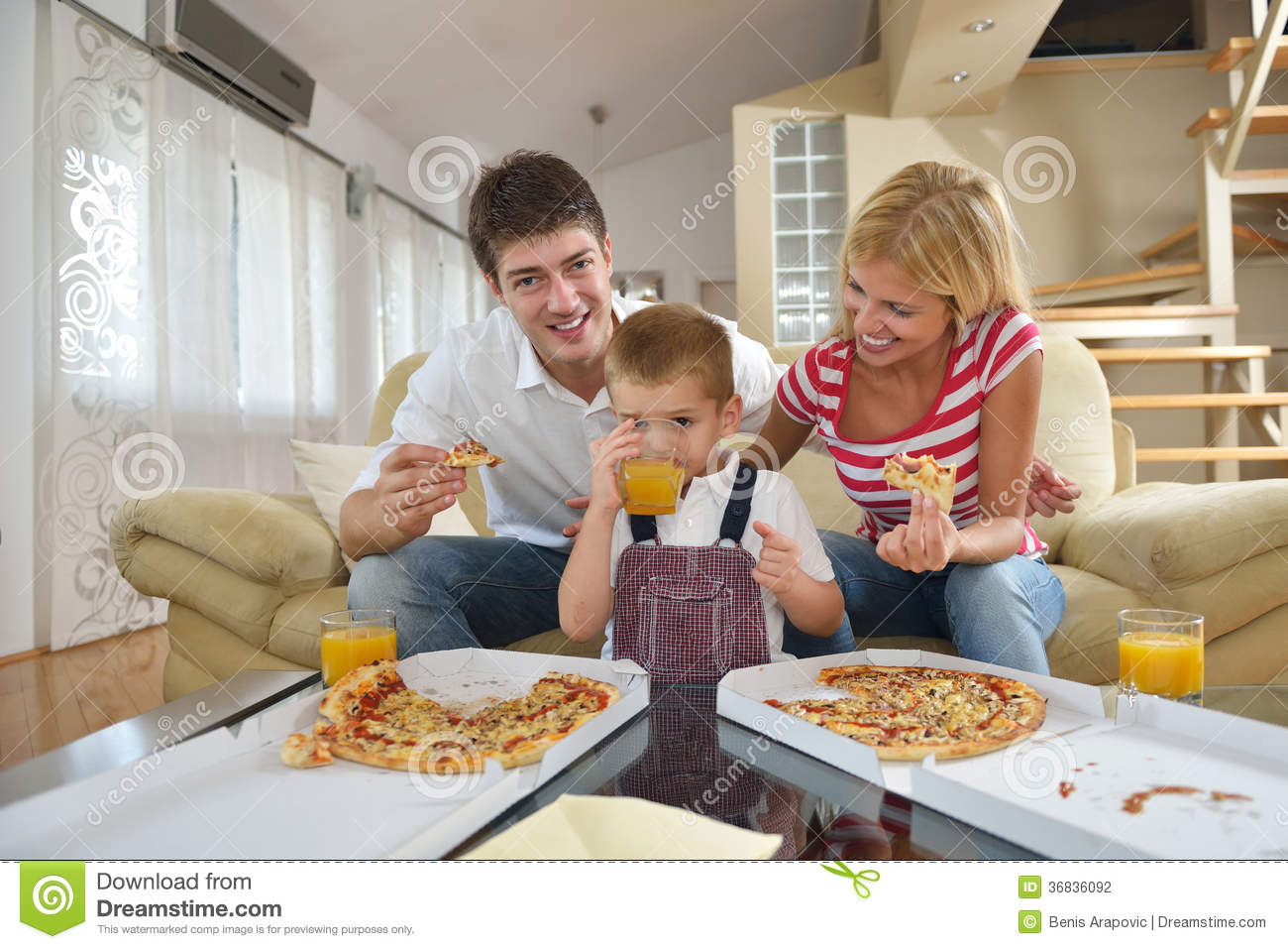 Happy Young Family Eating Tasty Pizza With Cheesa And Dring Healthy    
