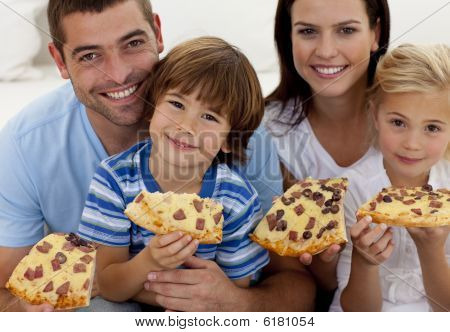 Picture Or Photo Of Smiling Parents And Children Eating Pizza On Sofa