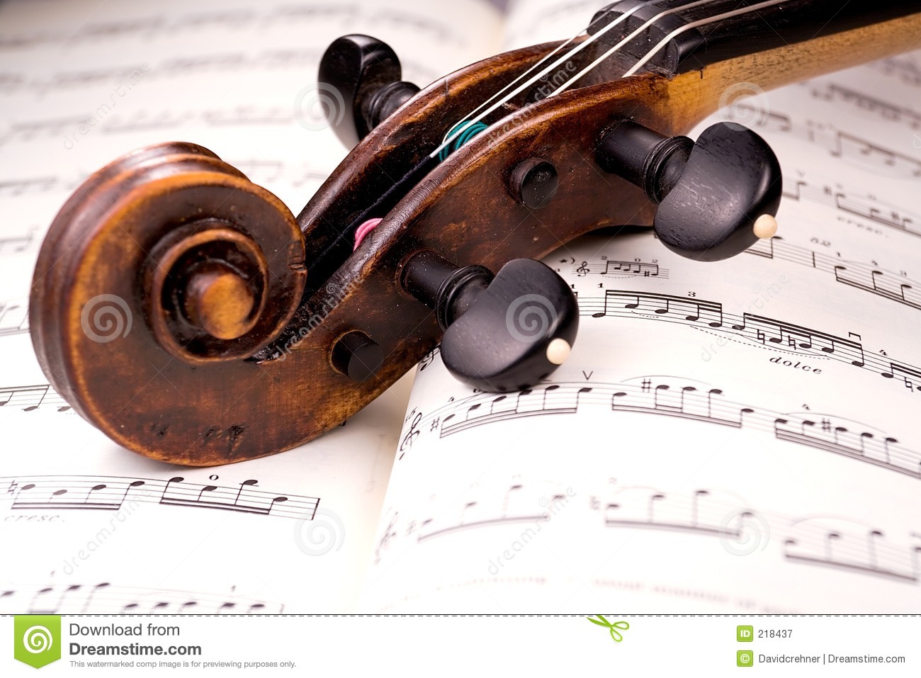 The Dusty Scroll Of An Old Violin Rests In The Middle Of A Musical    