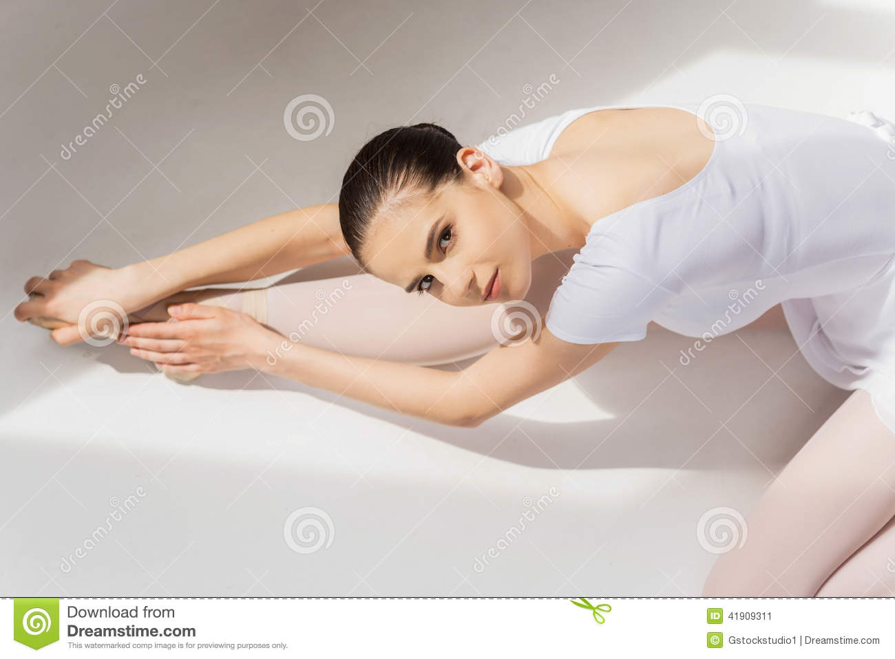 Top View Of Beautiful Young Ballerina Doing Stretching Exercises And    