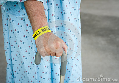 An Elderly Man Wearing A Fall Risk Bracelet Around His Wrist At The