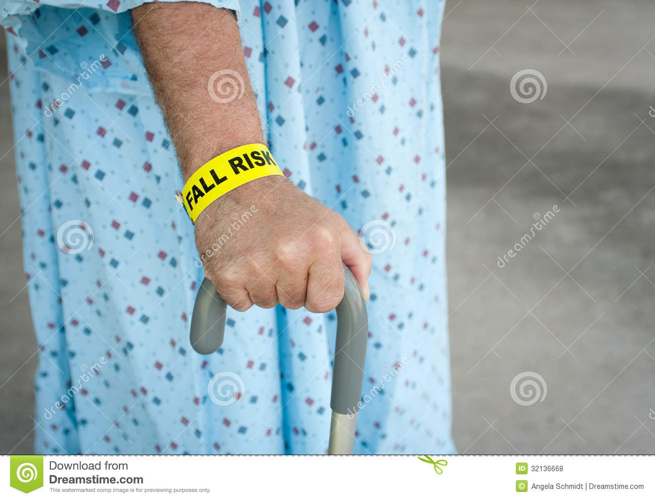 An Elderly Man Wearing A Fall Risk Bracelet Around His Wrist At The