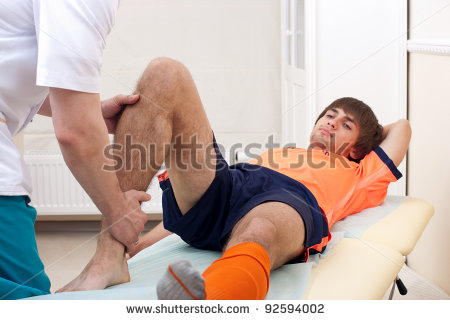 Doctor Testing A Knee For Stability Of Injured Football Player In    