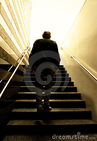 Old Man Climbing Stairs Into The Light Royalty Free Stock Photography    
