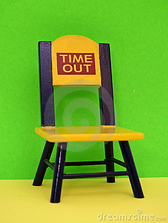 An Empty Yellow And Blue Time Out Chair Against A Bright Green Wall