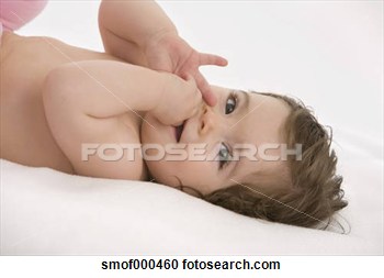 Baby Girl Lying On Back With Finger In Mouth Smiling View Large Photo    