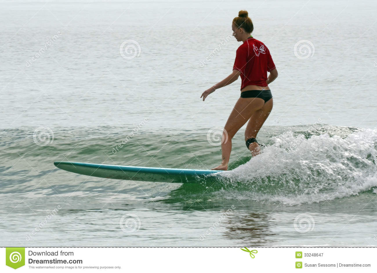 Longboard Surfer Girl Wearing Brazilian Cut Bathing Suit Catches A