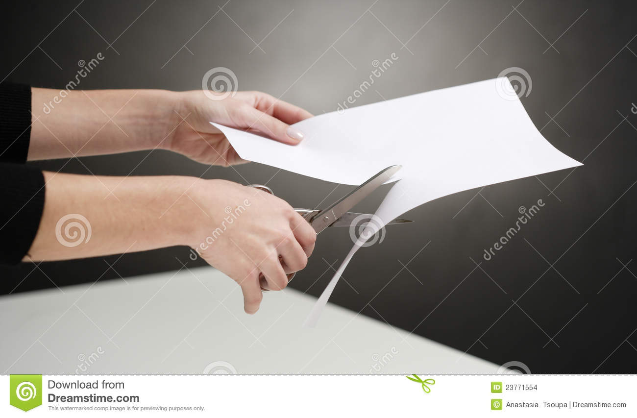 Hands Of Woman Cutting White Paper Over Table Black Background